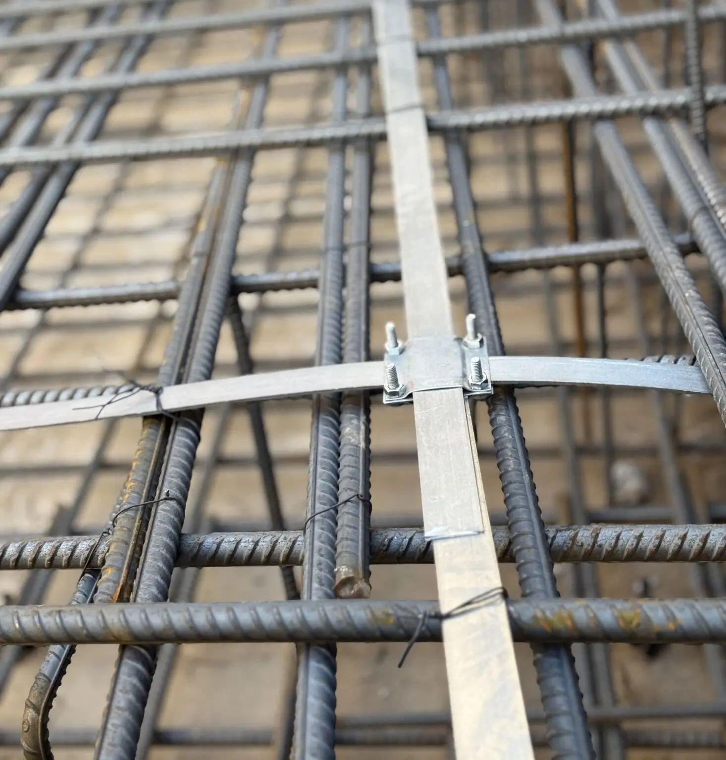 Professional electrician in uniform using screwdriver while installing electrical socket outlet